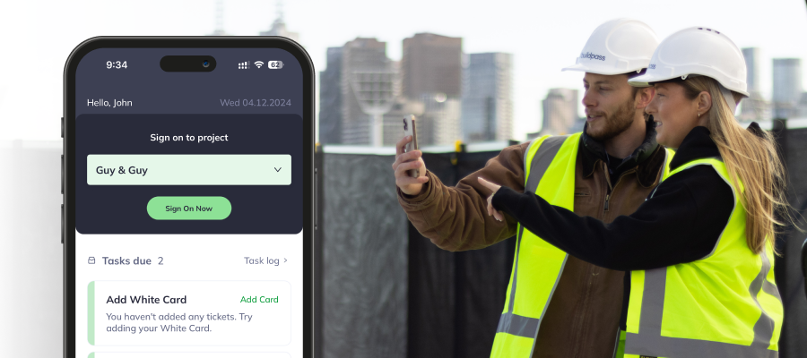 Mobile device showing BuildPass sign on screen with construction workers in the background.